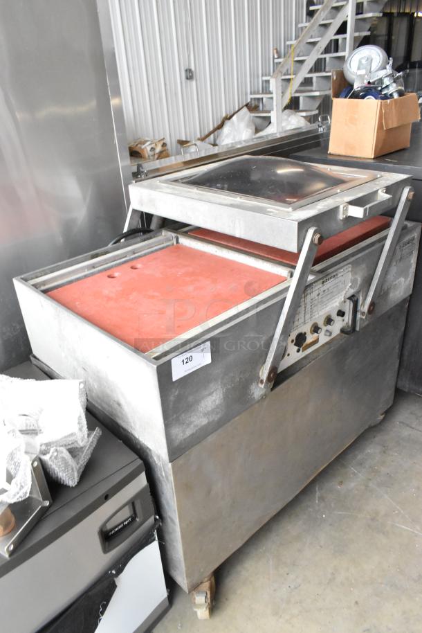 Bizerba stainless steel commercial vacuum sealer on casters. Heavy-duty, well-worn with visible controls and settings panel.