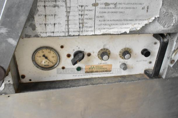 Bizerba stainless steel commercial vacuum sealer, used condition, control panel with dials, pressure gauge, on casters.