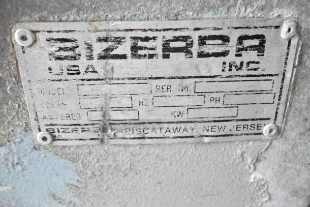 Bizerba stainless steel vacuum sealer on casters; industrial label with model and serial number sections visible.