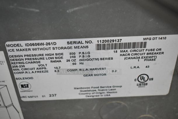 Manitowoc ID0606W-261D stainless steel commercial ice head, 208-230 volts, 1 phase. Label shows technical specs and UL certification.