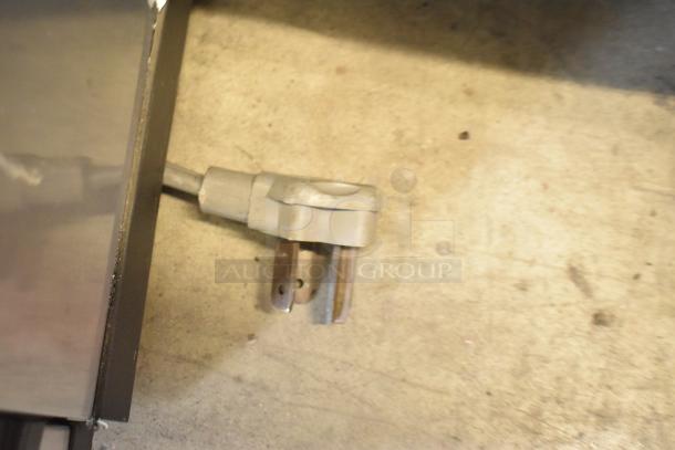 Stainless steel Manitowoc ID0606W-261D commercial ice head, 208-230V, 1 phase. Plug and power cord visible, indicating compatibility.