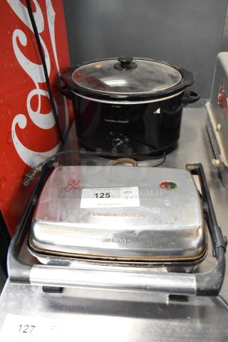 Hamilton Beach Panini Press and Slow Cooker. Both items in used condition, black and stainless finish, 120V, 1 phase.