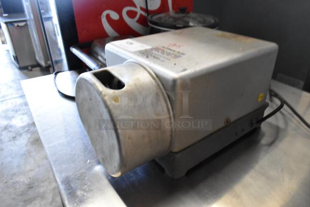 Prawnto MLG-1 metal shrimp deveiner, 115 volts, 1 phase, commercial countertop design. Visible wear on surface.