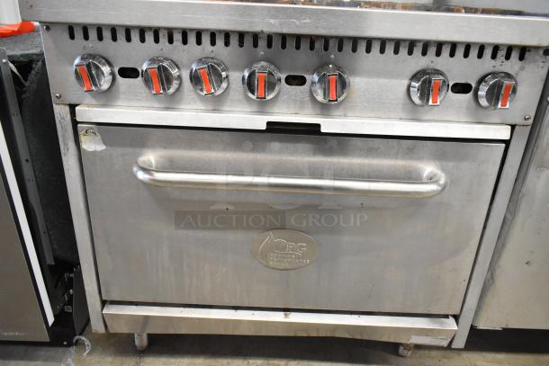 Cooking Performance Group stainless steel 6-burner gas range with oven, backsplash, overshelf; moderate wear visible.