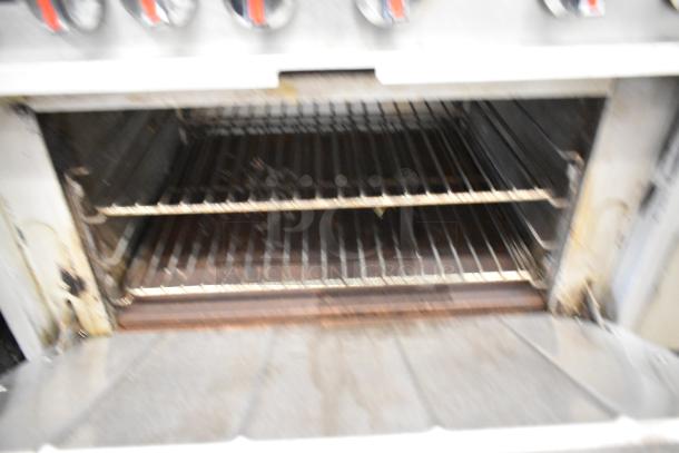 Cooking Performance Group gas-powered 6-burner range with oven, stainless steel, includes backsplash and overshelf, commercial-grade.