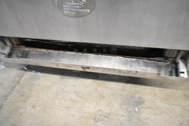 Cooking Performance Group stainless steel 6-burner gas range with oven, backsplash, and overshelf. Visible wear and markings.