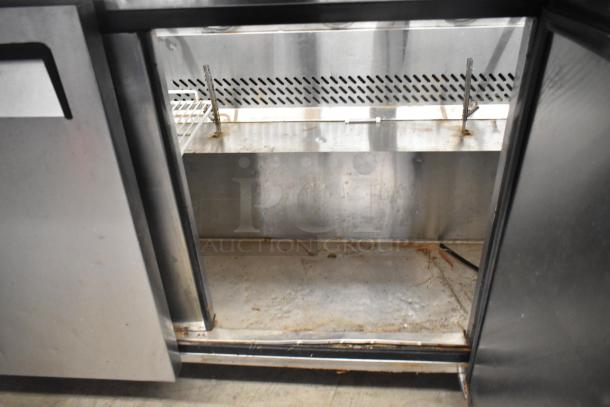 Atosa MSF8108 stainless steel commercial prep table interior, showing shelves and moderate wear. 115 Volts, 1 Phase.