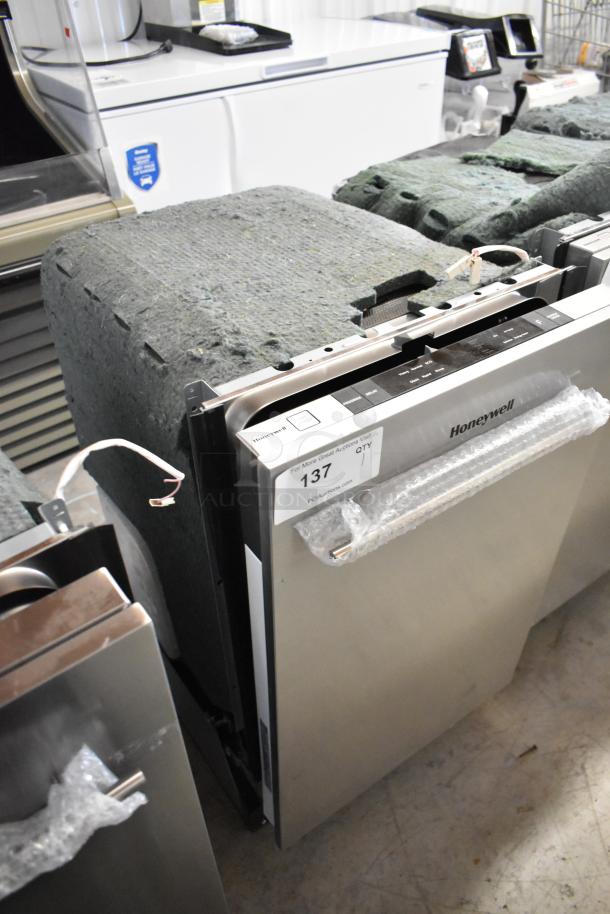 Honeywell HDS18SS 18" slimline dishwasher, stainless steel, new with minor scratches, wrapped handle, auction tag visible.