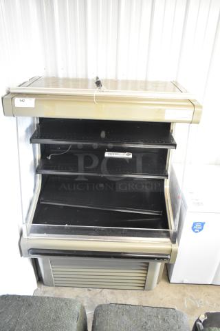 Hussmann GSVM4060 metal commercial merchandiser with shelves, featuring a gold-toned exterior. Used condition.