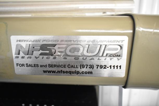 Hussmann GSVM4060 metal grab n go merchandiser with metal shelves, visible NFS Equip service label with contact info.