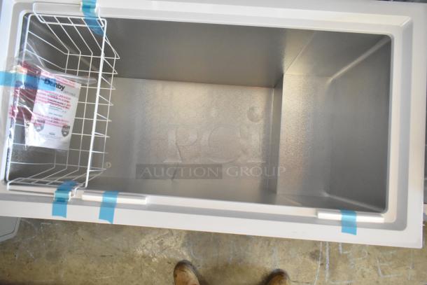 Brand new Danby DCF100A6WM metal chest freezer, hinge lid, visible interior label, 115V, 1 phase, minor scratches.