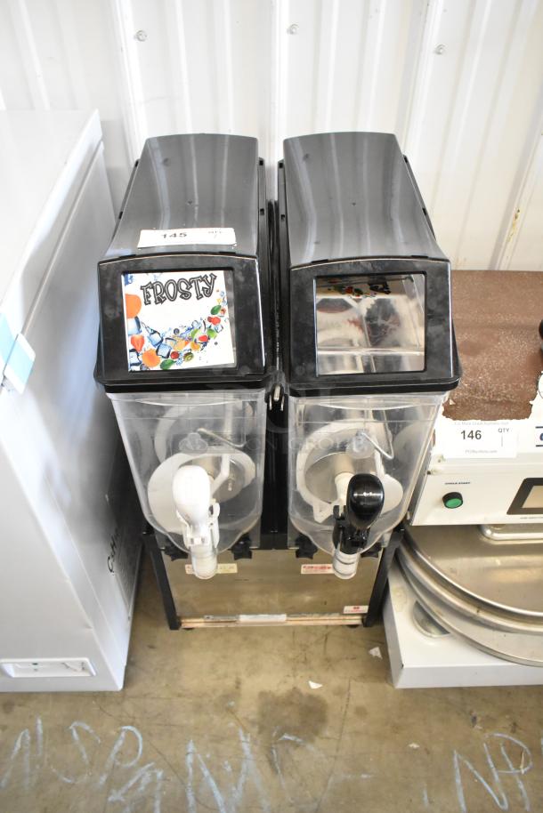 Crathco Stainless Steel Countertop 2 Hopper Slushie Machine, 115 Volts, 1 Phase, with dispensing nozzles and product label "Frosty."