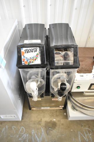 Crathco Stainless Steel Countertop 2 Hopper Slushie Machine, 115 Volts, 1 Phase, with dispensing nozzles and product label "Frosty."