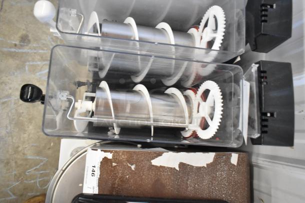 Crathco stainless steel countertop slushie machine with 2 hoppers, 115 volts, 1 phase. Visible gears and handle detail.