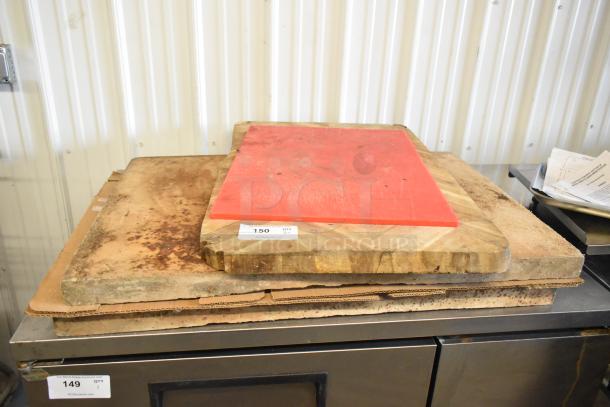 Two cutting boards: one red synthetic, one wooden, both show signs of use. Auction tags indicate item numbers 149 and 150.