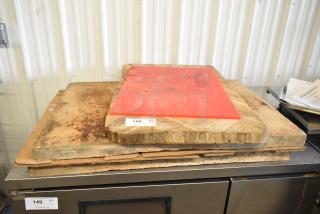 Two cutting boards: one red synthetic, one wooden, both show signs of use. Auction tags indicate item numbers 149 and 150.