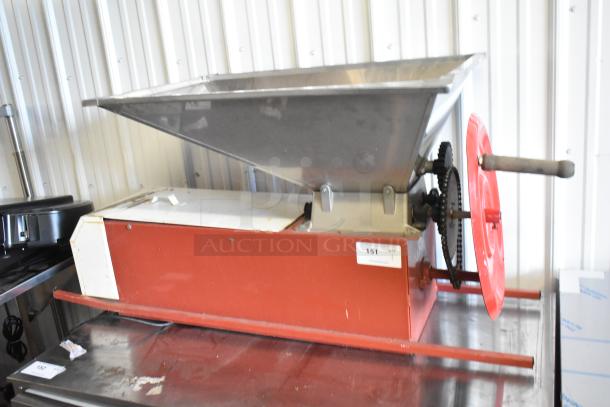 Pillan Metal Commercial Countertop Cookie Depositor; red, manual operation, stainless steel hopper, visible handle and gears.