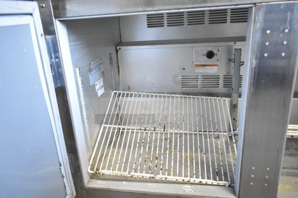 Beverage Air UCR48A stainless steel undercounter cooler, two-door, model UCR48A, 115 volts, interior shelf visible.
