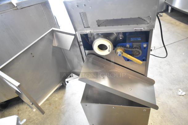 Stainless steel commercial countertop cookie depositor, open access panel, visible motor and gear mechanisms, in good condition.