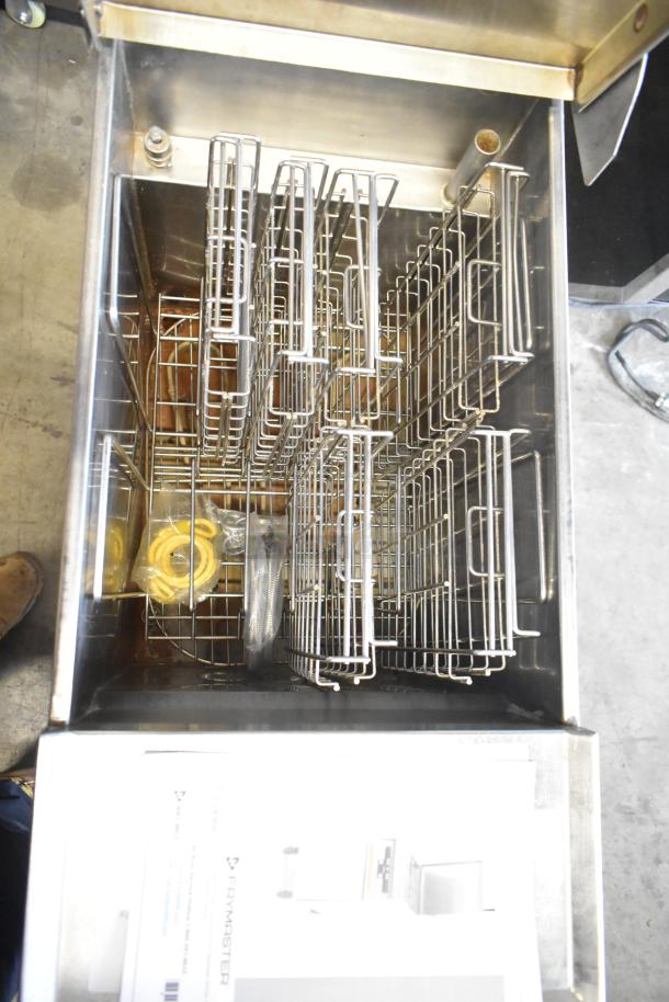 Frymaster stainless steel commercial rethermalizer with wire baskets, commercial casters, and accessories, in good condition.