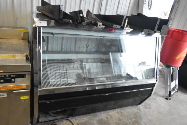 McCray SC-CMS35-6-BE metal deli display case, floor style, large glass front, commercial use. Model number visible.