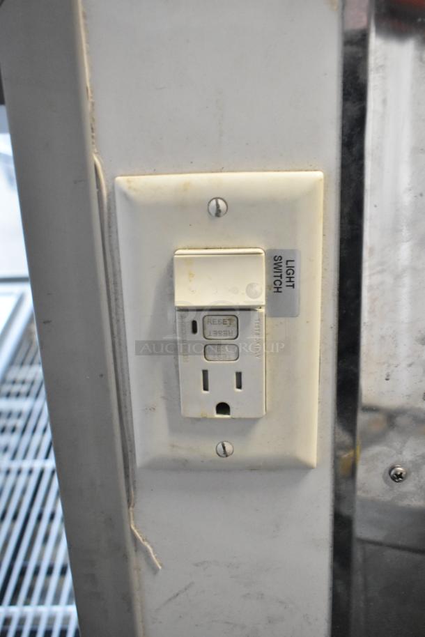 Electrical outlet and light switch plate on McCray SC-CMS35-6-BE deli display case, displaying signs of wear.