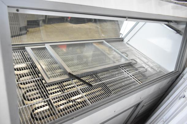 McCray SC-CMS35-6-BE commercial deli display case in metal, floor style, features clear front glass and internal metal grates.