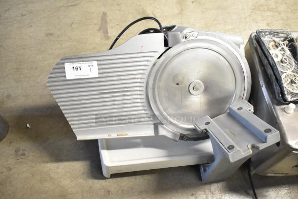 Metal countertop meat slicer, 115 volts, 1 phase. Missing carriage. Item tag: 161, qty 1. Used condition.
