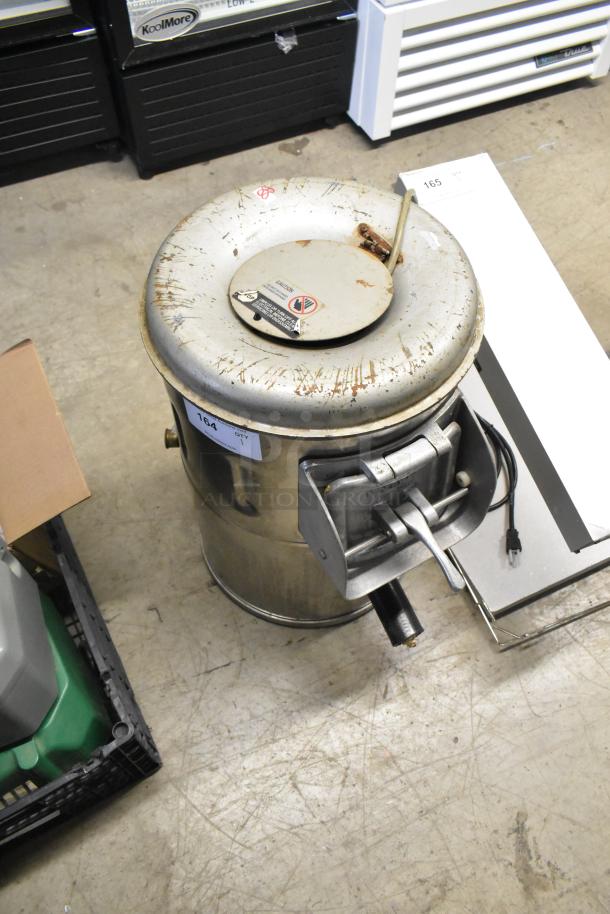 Univex metal commercial potato peeler, 115 volts, 1 phase. Visible wear and labels, sturdy construction ideal for high-volume use.