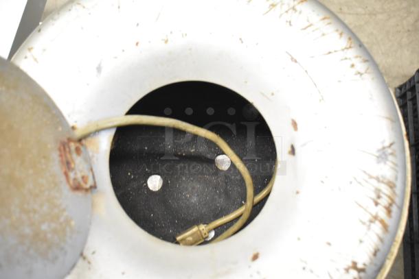 Univex metal commercial potato peeler, 115 volts, 1 phase, showing interior chamber and power cord; visible wear on exterior.