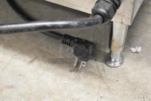 AvaToast 184T3300B toaster oven power cord and stainless steel leg on concrete floor. 208V, 1 Phase.