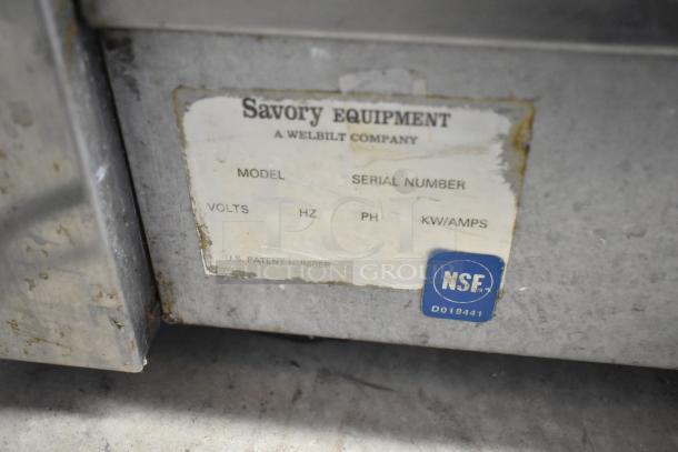 Savory stainless steel commercial countertop hot dog roller with label showing model, serial number, and NSF certification.