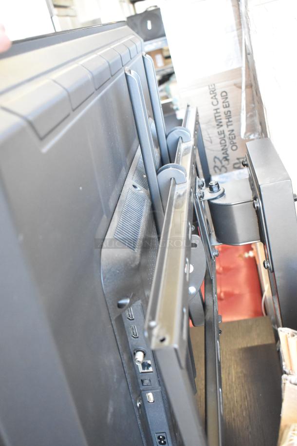 Samsung Television on stand, good condition, visible ports and mounting brackets. Buyer must pick up; no shipping.