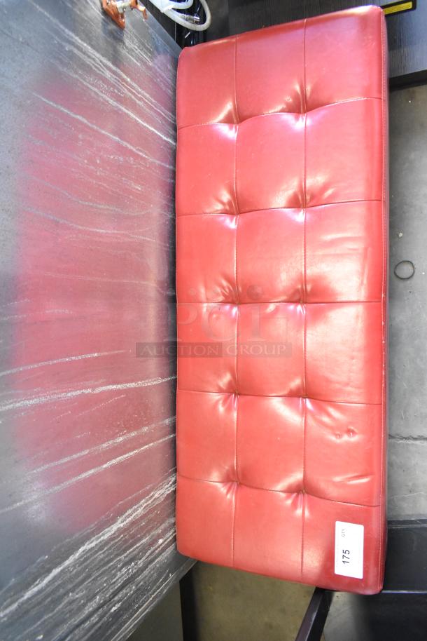 Red leather bench with a tufted cushion design. The bench is in good condition with a label indicating "175 qty."