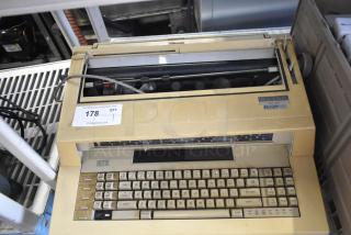 Sharp ZX-515 Countertop Typewriter, vintage model, beige casing, visible wear, 115 volts, 1 phase, label indicating auction item 178.