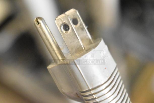 Close-up of a power plug for the Sharp ZX-515 Countertop Typewriter, 115 volts, 1 phase, showing prongs and plug details.