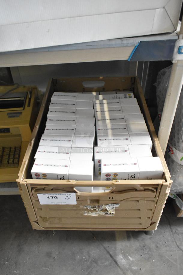 Lot of Art-n-fly 12 Brush Markers in original packaging, neatly stacked in a crate. Condition appears new. Auction lot 179.