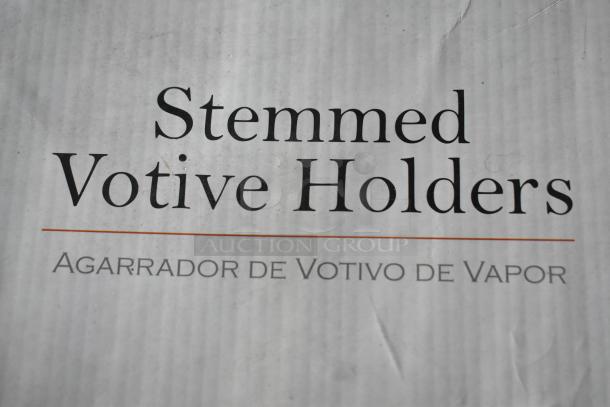 Box labeled "Stemmed Votive Holders" with text "Agarrador de Votivo de Vapor"; appears to be in good condition.