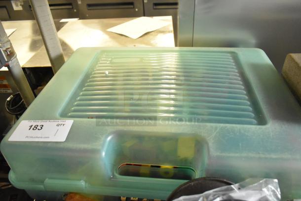 Lot of Lego building blocks in a green hard case with a handle. Case labeled "183" for auction.