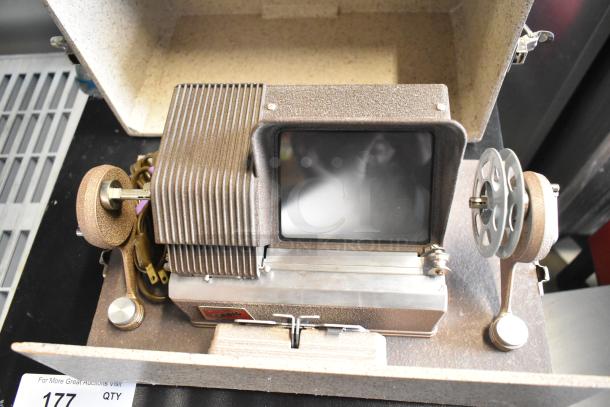 Craig KE-8 Projecto-Editor in hard case, features 110-120 volts, 1 phase. Includes screen and reel mechanism, good condition.