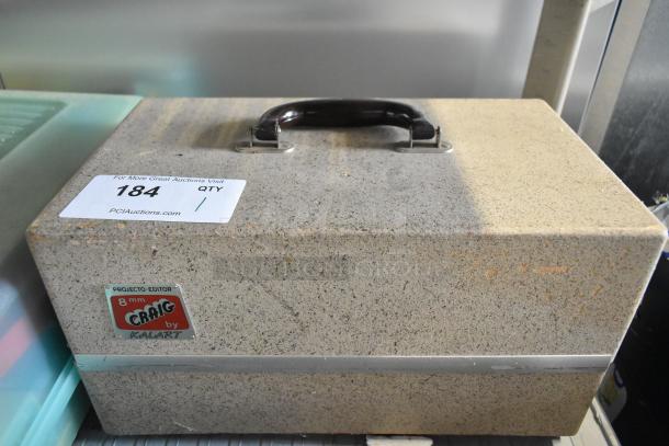 Craig KE-8 Projecto-Editor in hard case. Features 110-120 volts, 1 phase. Includes handling sticker and brand label.