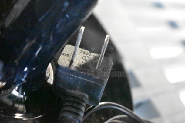 Close-up of a power plug from one of three monitors: Asus VG249, Samsung S23C350H, HP. Condition details not visible.