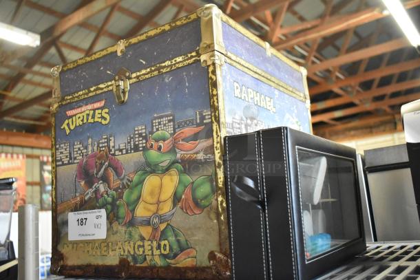 Wooden Ninja Turtles box with Raphael design, visible wear; black leather watch case with clear viewing window, as is condition.