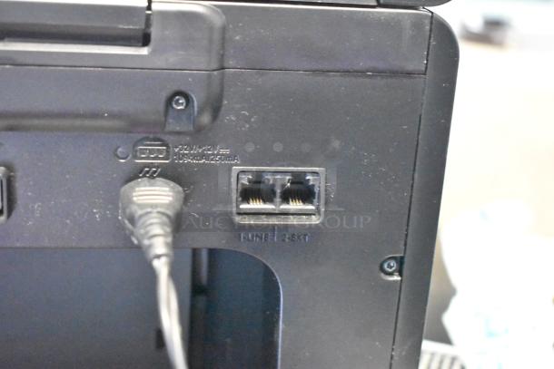 HP countertop printer scanner copier, rear view showing power and phone line ports, labeled "LINE" and "EXT".