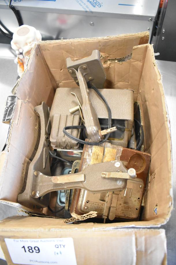 Lot of various items in torn cardboard box, including Mansfield 950 8mm editor. Mixed vintage electronics and accessories.