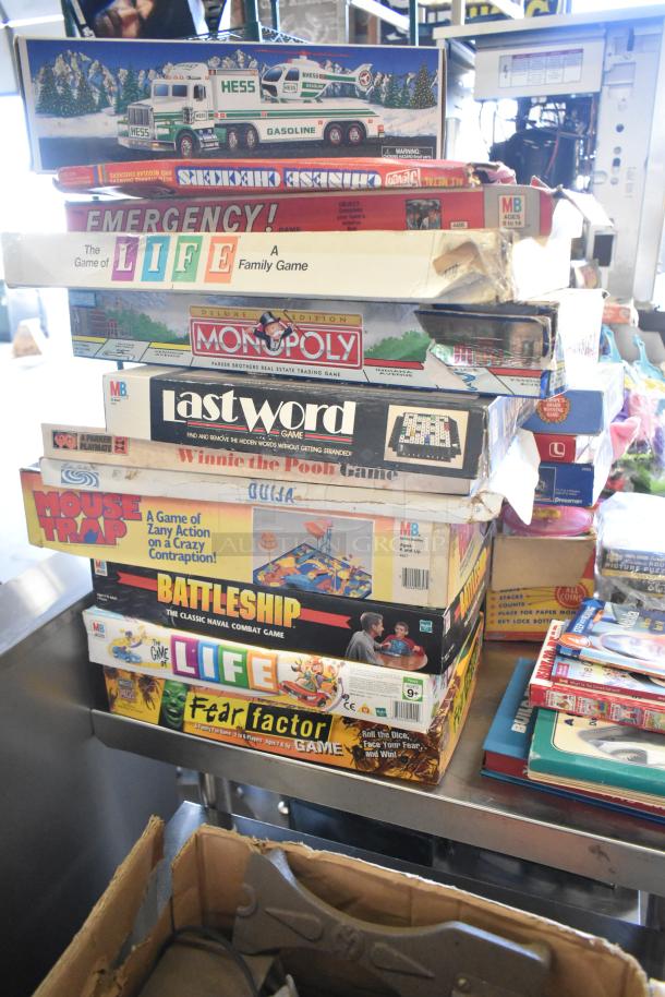 Tiered lot of board games including Monopoly, Battleship, and Life, plus books. Boxes show wear, various conditions.