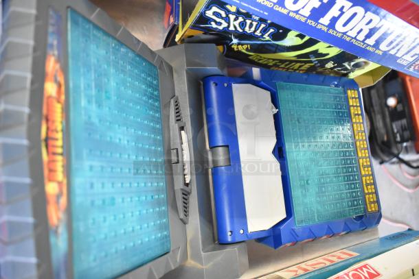 Board games and books tier lot, featuring "Wheel of Fortune" and mystery-themed titles. Condition appears good.