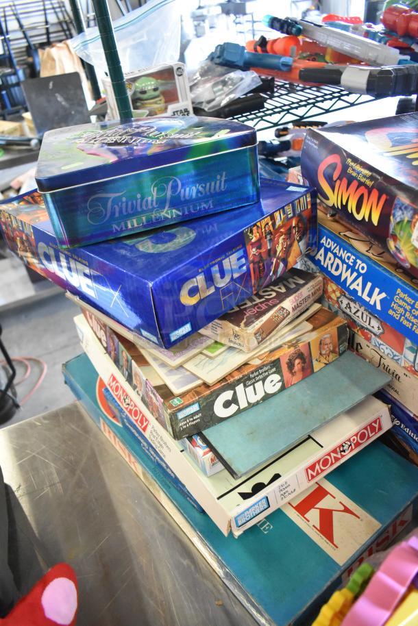 Tiered lot of board games and books, including "Trivial Pursuit Millennium," "Simon," "Clue," "Monopoly," varied conditions.