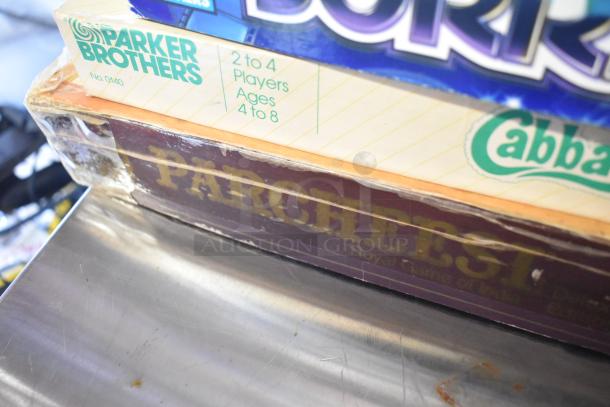 Tiered lot of board games including Parker Brothers' games, visible wear, includes games for ages 4-8, 2-4 players.