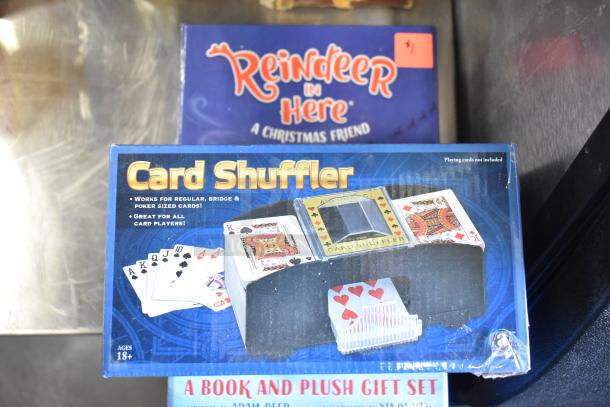 Tier lot with card shuffler, Reindeer in Here book, and a book with gift set. Items in fair condition.